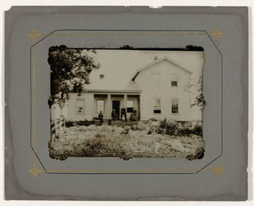 Wooden house with the inhabitants in front, in a wooden frame