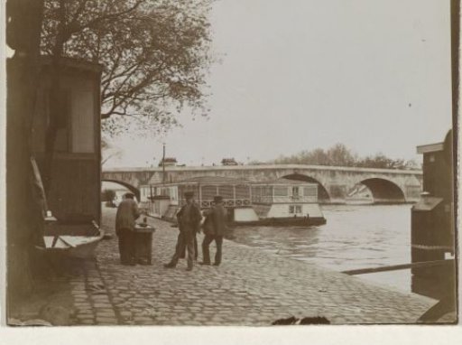 Four men on the quay near the Pont Royal in Paris