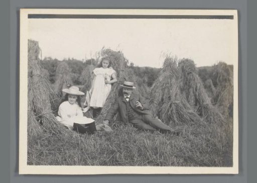 Portrait of Johanna (Nan) Vreede, Johanna (Hans) de Jong and Willem de Jong by Stacks of Hay in a Meadow
