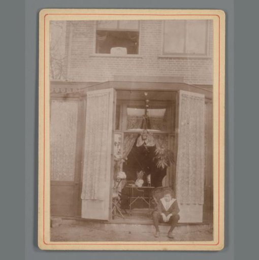 Ewoud (Dick) Vreede sitting on the doorpost of his uncle Willem de Jong's house in Leiden