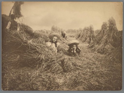 Johanna (Hans) de Jong and Johanna (Nan) Vreede among stacks of hay in a meadow