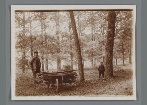 Man and boy with a wheelbarrow in the woods