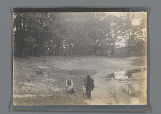 Portrait of a Boy and a Man Working in the Forest by a Stream