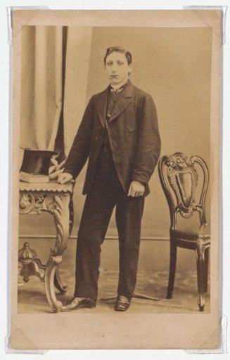 Portrait of a standing man with a tall hat