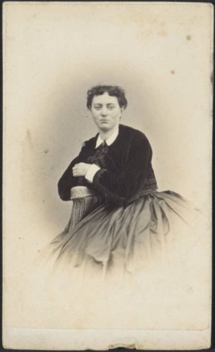 Portrait of a seated woman in a blouse and a skirt