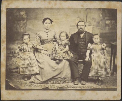 Family portrait of a married couple with three small children in checkered dresses, possibly belonging to the Nathanson, Hannover family