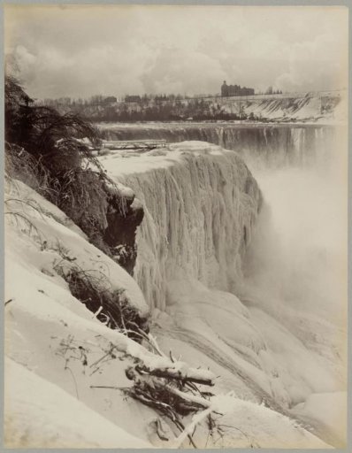View of the frozen Niagara Falls with buildings in the background