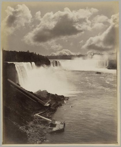 View of Niagara Falls with a boat and a pier