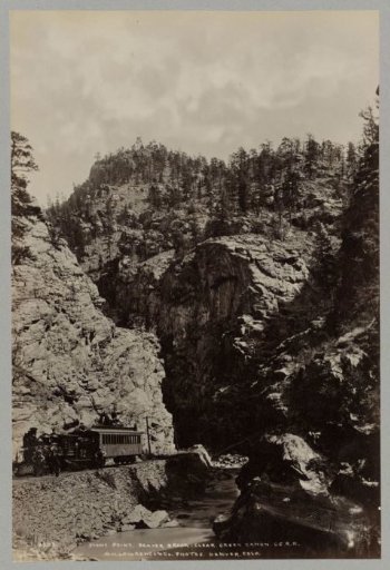 Men posing next to a C.C.R.R. train at Stony Point in Clear Creek Canyon