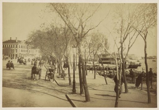 Quay in Shanghai with people, rickshaws and boats