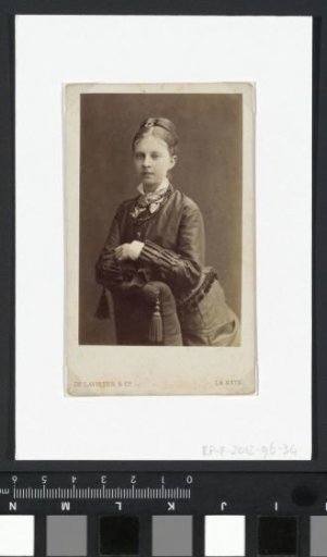 Portrait of a woman leaning on an armchair