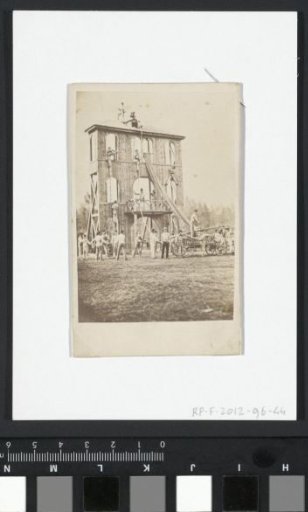 Men at a wooden facade under construction