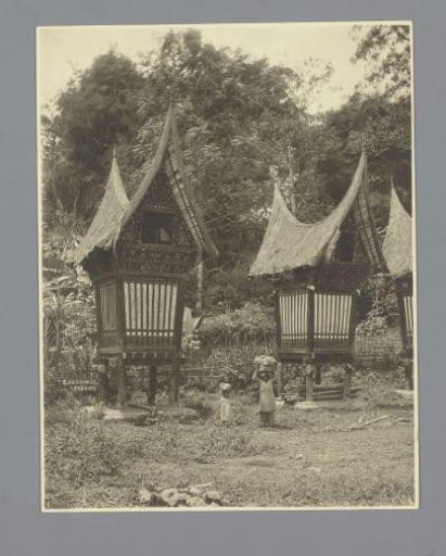 Houses of a Batak Village, with Two People Carrying Goods on Their Heads, Padang