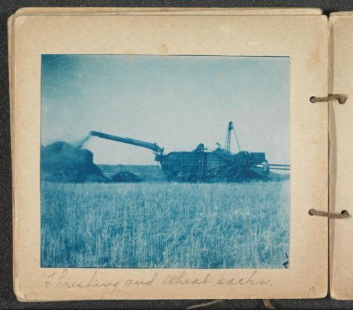 Threshing machine in a grain field
