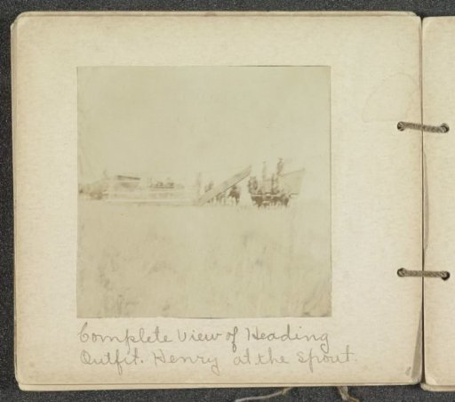 Cutting head of the reaping machine, horses and farmers nearby