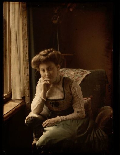 Woman seated by the window