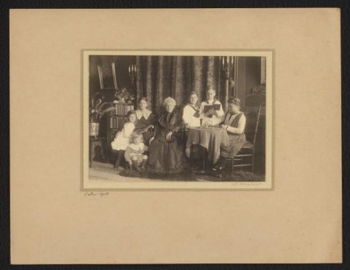 Group portrait of six unknown children and an old woman