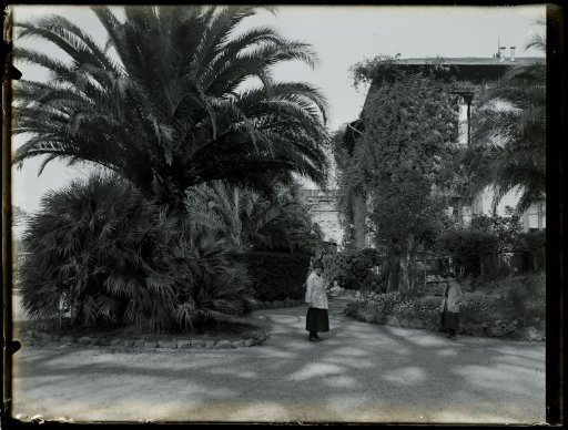 Two women in a garden of a villa, possibly Italy