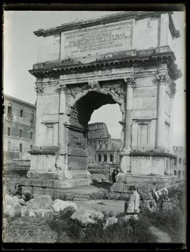 Arch of Titus on the Roman Forum, with the Colosseum in the background, in Rome