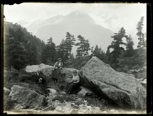 Portrait of an unknown man and two unknown women in a mountain landscape