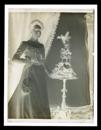 Portrait of an Unknown Woman Beside a Side Table with a Flower Arrangement