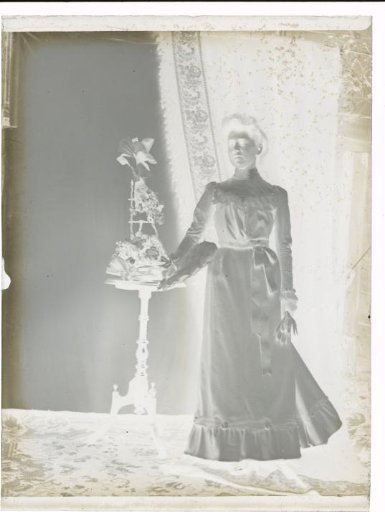 Portrait of an Unknown Woman Beside a Side Table with a Flower Arrangement