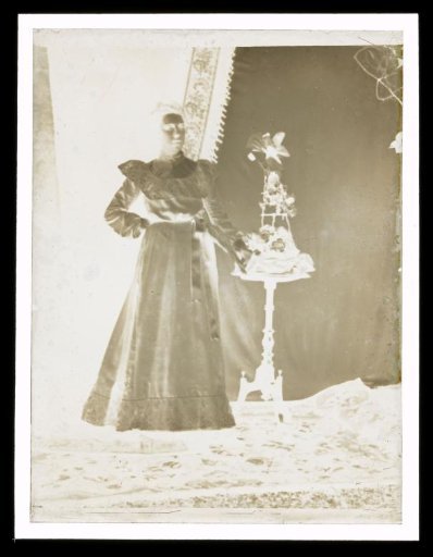 Portrait of an Unknown Woman Beside a Side Table with a Flower Arrangement