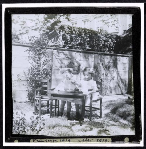 Two Young Girls at a Children's Table in the Garden