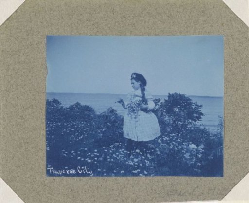Girl with flowers on the coast at Traverse City in Michigan