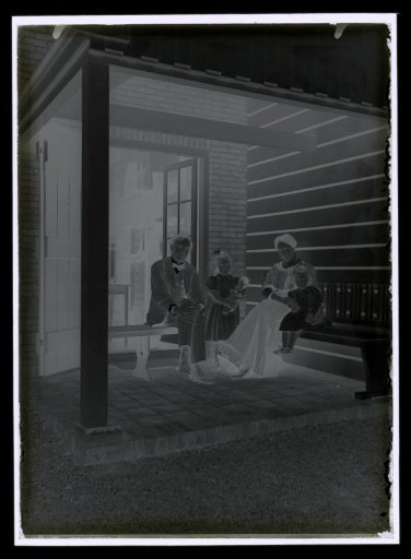 Elsa and Alphons Diepenbrock with children Joanna and Thea on a veranda, possibly of their residence 'Holtwick' at Laren