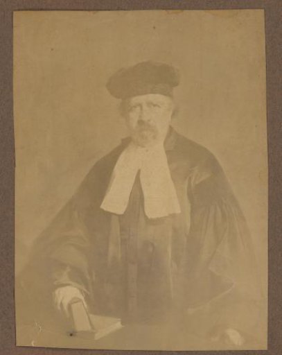 Man with a cap and books