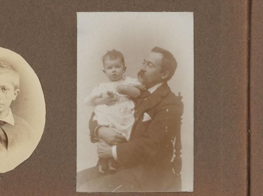 Seated man with a child in his arms