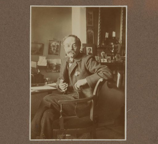 Alphons Diepenbrock seated at a desk