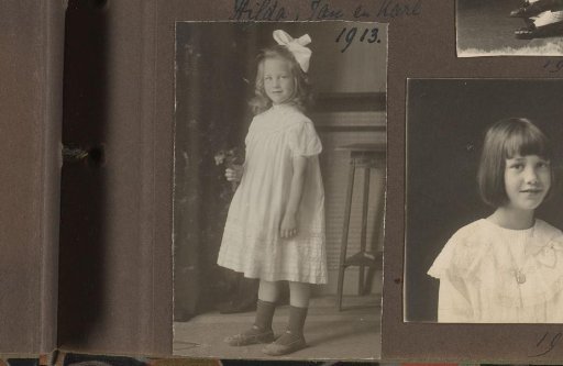 Portrait of Thea Diepenbrock standing with a flower in her hand and a bow in her hair