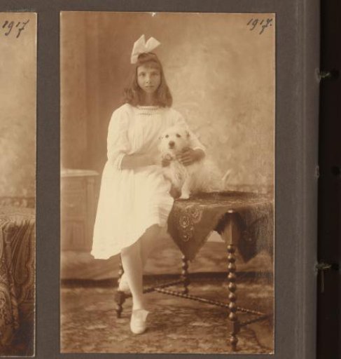 Studio Portrait of an Unknown Girl Sitting on a Table with a Dog