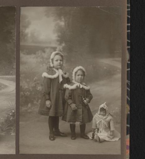 Studio portrait of Joanna and Thea Diepenbrock with a doll