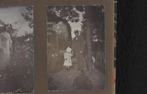 Alphons Diepenbrock standing in the garden of Villa de Hoeve with a toddler by the hand, presumably his daughter Thea or Joanna