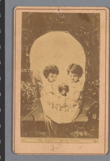 Photographic reproduction of a design of two children and a dog forming the eyes and nose of a skull