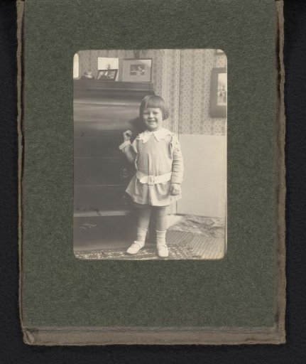 Portrait of Cay van den Berg, standing in front of a chest of drawers