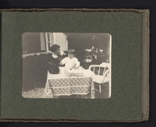 Woman, possibly Line, with Cay van den Berg on her lap at Hotel Bosch van Bredius in Laren