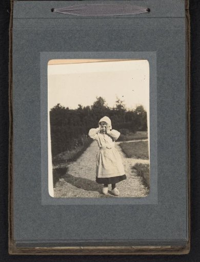 Cay van den Berg, dressed as a milkmaid, in the garden at Blaricum
