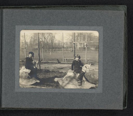 Carel and Frank van den Berg on toy horses in a park