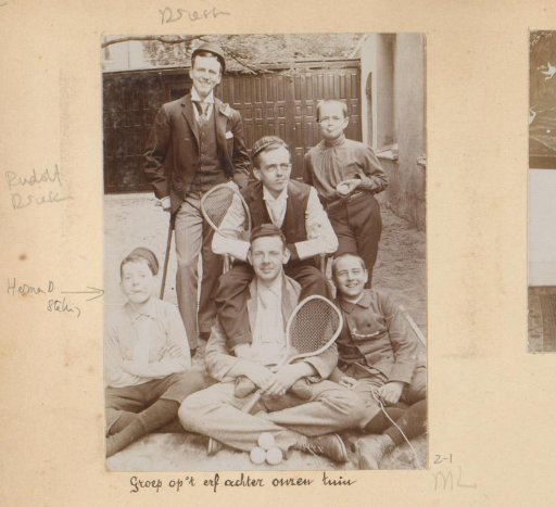 Group portrait of several boys and young men on the yard behind the garden of the Van den Berg family