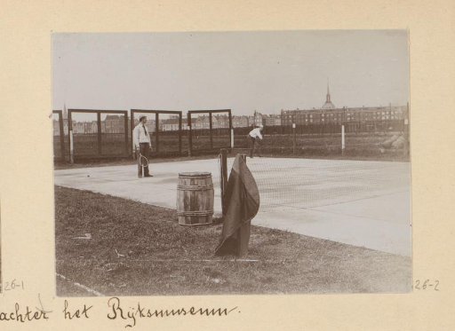 Two men playing tennis on the grounds behind the Rijksmuseum