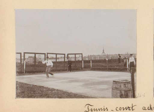 Two men playing tennis on the grounds behind the Rijksmuseum