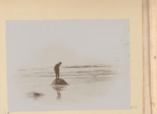 Man standing on a sand dune on the beach of Scheveningen