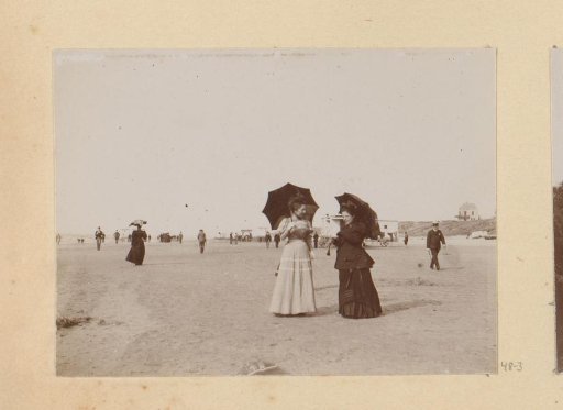 Two women with parasols on the beach