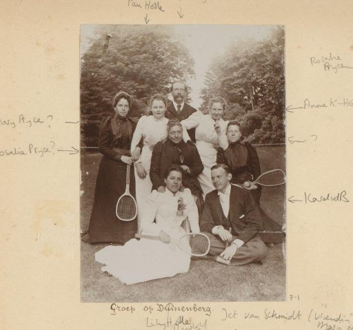 Group portrait of a company with tennis rackets in the grass at Duinenberg
