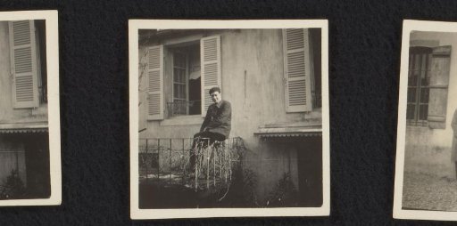 Man on a balcony in front of a house