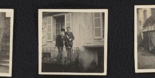 Two men in front of a house